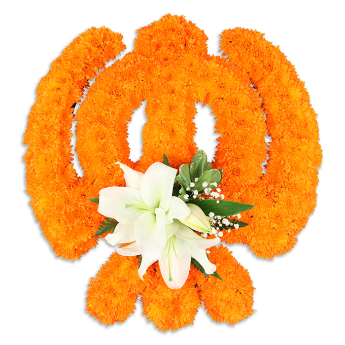 Set against a clear white backdrop, this floral Ik Onkar is a meticulous expression of devotion, sculpted entirely from thousands of vivid orange marigold heads to read as one unified emblem. The traditional components-the ascending '1' (Ek), the subtle crescent-like curves and the small dot (bindi) that together signify 'God is One'-are carefully modelled by the dense, warm marigold surface so each line and curve holds a soft, celebratory glow. Centrally anchored at the lower portion of the orange form is a refined cluster of white lilies: at least two fully opened blossoms with elegant, slightly recurved petals and pale green-yellow stamens, surrounded by a handful of tight buds that suggest ongoing life and renewal. Sprigs of deep green foliage, likely salal or similar leaves, frame the lilies while delicate baby's breath adds a veil of tiny white points, providing both contrast and depth. The studio lighting lifts the marigolds' texture and creates a gentle drop shadow, giving the Ik Onkar a sculptural, almost floating presence that reads as a physical tribute rather than a flat graphic. This composition conveys solemnity and celebration at once-appropriate for Vaisakhi, Guru Nanak Jayanti, or a community remembrance-and feels particularly at home in local settings around Stanmore Broadway, near Canons Park or at gatherings convened by families across the neighbourhood. The overall mood is one of quiet reverence rendered with traditional flowers and skilled craftsmanship.