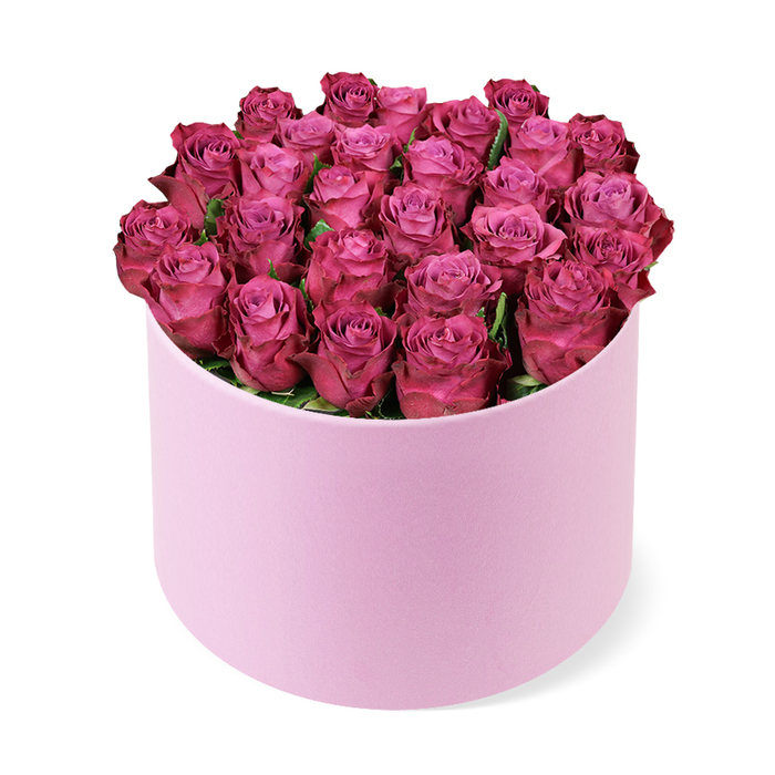 A refined, high-fashion bouquet, this arrangement gathers dozens of tightly curled roses in a deep fuchsia or magenta, grouped into a lush dome that fills the pale pink hat box from rim to rim. The petals glow with a subtle gradient, lighter at the centers and growing richer toward the edges, while only a few dark green leaves peek shyly between heads. The round box, with its velvety matte texture, provides a soft, sophisticated counterpoint to the roses' velvety sheen, creating a tactile harmony between container and blooms. The composition sits upright on a bright white background, the lighting crisp enough to reveal every petal's curve and every shadowed dip in the dome. This image celebrates beauty, romance, and luxury, and it's easy to imagine it gracing a Valentine's night table, an anniversary surprise, or a premium gift in a Stanmore boutique window. The piece also reads as a thoughtful display for premium floral delivery services in NW London, where customers in Stanmore and Canons Park can expect fresh, same-day options to brighten a home or office. The overall effect is one of timeless sophistication, a modern classic that mirrors the careful craft of a local florist who understands both romance and refined taste. A lingering rose scent, soft to the senses, completes the experience when the arrangement is opened in a bright living room.