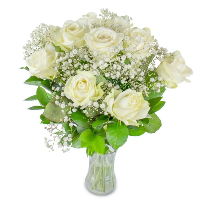 This bouquet tells a quiet story of refined celebration and soft remembrance through a harmonious pairing of white roses and airy baby's breath. Approximately twelve roses form an ensemble of cream-toned blossoms-some opened wide in full welcome, others still cupped in a more private bloom-each petal edged with the faintest blush of ivory and layered with velvety smoothness. Encircling and threading through the roses, clusters of gypsophila act like a delicate lace, their minute, star-like flowers giving the whole arrangement an almost starlit halo. Beneath and between, varied greenery in deep and lighter greens cradles the flowers; the leaves' satiny surfaces and visible veins provide structure and a cooling counterpoint to the warm cream of the roses. The stems are neatly cut and shown in a clear glass vase, where the waterline and bundled stems reassure of recent trimming and careful handling. The lighting is soft and even, highlighting texture and creating gentle shadows that enhance the bouquet's three-dimensional calm. The scent is unobtrusive-a fresh, green whisper that invites a pause. From a florist's viewpoint, arranging such a bouquet feels like composing a quiet moment: suitable for a wedding table near Stanmore Park, a thoughtful birthday sent along Stanmore Road, or a remembrance placed in a sitting room after a service. Its understated elegance speaks of steady affection and composed grace.