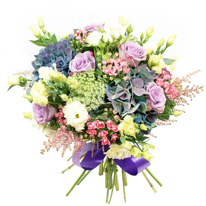 Arranged with devotion by local Stanmore florists, this elegant bouquet is an ode to the area's unique charm, from its stately tree-lined roads to its close-knit community spirit. Deeply coloured hydrangeas in indigo and teal nestle alongside muted purple for an arresting centrepiece, their velvety petals inviting both admiration and touch. Encircling these, exquisitely layered roses in pale lilac and creamy white unfold slowly, their essence lending the bouquet a refined, timeless quality ideal for significant occasions or heartfelt gifts. Ruffled white ranunculus add sculptural beauty and plushness, harmonising with fresh, pale yellow lisianthus whose slender buds and partial blooms lift the composition, much like morning sunlight over the gardens of Stanmore Hill. Vivid sprays of fuchsia-pink and soft pink astilbe contribute lightness and playful colour, while finely textured green-white fillers, echoing wild plants found exploring local woods, thread through the arrangement to offer delicate contrast. Deep green foliage shapes the frame and underscores each colour's vibrancy. Carefully tied at the stems with a lavish royal purple satin ribbon, the bouquet is both abundant and perfectly balanced-a symbol of joy, admiration, and the professional artistry of Stanmore's finest florists.