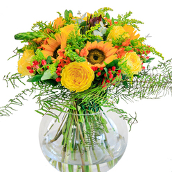 Bathed in gentle, diffused light, this captivating bouquet brings a piece of Stanmore's natural beauty indoors. Sunflowers stand in the center with golden faces turned eagerly outward, echoing the abundant blooms you might spot on a stroll through Canons Park. Creamy yellow garden roses swirl open in plush, velvety spirals, radiating warmth and familiarity-just like the friendly greetings you receive along Marsh Lane. Ruby-red Hypericum berries sprinkle energy throughout, contrasting joyfully with the dominant golds and verdant foliage. Cascading fern and airy goldenrod add soft, feathered movement, their textures reminiscent of the wild growth edging Stanmore's open fields. Among the greenery, subtle blue-green eucalyptus leaves add depth and a soothing, fresh scent. The bouquet rests in a perfectly round, transparent glass vase, where clean water magnifies the lively arrangement of stems and brings a sense of modern refinement. Imagine the uplifting fragrance-hinting at open meadows and sun-warmed petals. Designed for joyous moments and heartfelt occasions, this bouquet is a true celebration of community, brightening homes and spirits across Stanmore with every petal and leaf.