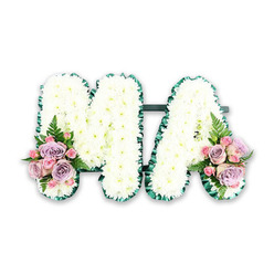 This image presents a refined funeral flower tribute spelling the word MA, thoughtfully arranged for a mother's farewell and photographed against a bright white backdrop. The letters are substantial and easily readable, yet they carry an air of softness that would sit beautifully in a quiet service in or around Stanmore. Every part of the M and A is densely covered with small white chrysanthemum heads, their numerous petals layered tightly to create a seamless, pillow-like surface. The flowers form gentle mounds that catch the light, lending a subtle depth and shadow across the tribute. Around the outer edges, a deep emerald green ribbon forms a continuous border, delicately gathered to echo the contours of each letter. This polished frame brings contrast and clarity, much like the neat tree-lined roads leading toward Stanmore Hill and Bentley Priory. At the base of the left stroke of the M and the right stroke of the A, the florist has tucked in symmetrical accent sprays. These are formed from soft pink roses, lilac roses, and dainty pink spray roses, combined to create a romantic palette of blush and lavender tones. Some blooms are tightly furled, others open and full, with velvety petals that appear almost silky to the touch. Wisps of fern and fresh green foliage extend gently from the clusters, adding a sense of movement and lightness, as if a soft breeze had passed through a garden. The finished tribute feels both formal and affectionate, a fitting piece to accompany a coffin, adorn a graveside, or be placed near a memorial table at a service in Stanmore, quietly saying thank you, Ma in flowers rather than words.