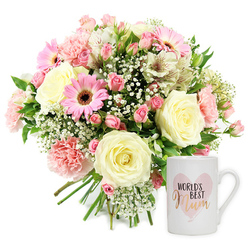 A beautifully balanced floral gift set, ideal for honouring a special mum in Stanmore, is photographed against a pure white background that enhances its delicate colours. To the left, a lush, rounded bouquet sits slightly angled, its gathered stems peeking out neatly at the base. Cream, blush, and varied pink tones blend together in a harmony of textures and shapes. Several fully open cream roses form the central cluster, their unfurling petals soft and velvety, suggesting tenderness and long-lasting love. Around them, pale pink carnations with gently frilled edges and darker pink spray roses create a layered effect, reminiscent of the tree blossoms lining streets near Stanmore Broadway in spring. Bright pink gerbera daisies, their wide petals radiating from dark central disks, add confident pops of colour, giving the display a lively, cheerful character. Slim, trumpet-shaped white alstroemeria are interspersed throughout; their petals carry subtle reddish-brown streaks that introduce an understated sophistication and draw the eye closer. Airy clouds of white gypsophila float between the larger blooms, making the bouquet feel light and romantic, while scattered greenery offers a fresh, garden-like contrast. To the right of this floral dome, a classic white ceramic mug stands upright. On its front is a soft, watercolour-style pink heart, framing the sentiment "WORLD'S BEST Mum." The words "WORLD'S BEST" appear in a simple black typeface above the word "Mum," which is rendered in a graceful, metallic gold or rose-gold script that glows gently against the white surface. The overall composition evokes a sense of appreciation and homely warmth, the kind of thoughtful set that could be delivered by Flowers Stanmore for Mother's Day, a milestone birthday, or just to remind a mum in Stanmore how cherished she truly is.