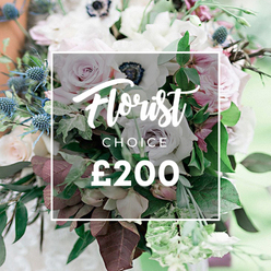 Intimate and refined, this Florist Choice bouquet appears as if curated for a Stanmore celebration or thoughtful gesture. The design centers on open light pink garden roses and creamy white anemones, their dark centers catching the eye, with a subtle drift of purple-grey roses weaving through to provide contemporary elegance. A cluster of blue eryngium thistles punctuates the arrangement, their spiky forms and cool blue tones offering a striking contrast to the softness of the petals. The bouquet is set within a lush framework of greens, including slim eucalyptus stems and deep burgundy leaves, giving it depth and a sense of garden-grown abundance. The shot relies on soft, natural daylight, with a clean, out-of-focus backdrop that evokes a Stanmore terrace or parkland edge where people might stroll with a bouquet in mind. In the center, a semi-transparent white box overlays the image, displaying Florist CHOICE and the price ?200 in crisp white type, a clear signal of a curated, premium option. The arrangement exudes a timeless charm suitable for a wedding centerpiece, an anniversary surprise, or a sophisticated home display for someone special in the Harrow area and beyond. Crafted by a local florist with an eye for texture and balance, it promises freshness, reliable delivery, and a refined, lasting impression that fits contemporary Stanmore lifestyles. Delivery is available across Stanmore and surrounding Harrow communities.