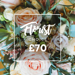 A vibrant, intimate overhead view of a curated bouquet that feels both romantic and slightly wild, crafted from soft pastel roses and natural accents. Dominant are several large blooms in blush pink, creamy white and pale peach, their petals unfurling with a plush, tactile quality; interspersed are muted lavender or dusty mauve roses that deepen the palette without losing the soft, airy mood. Small, delicate fillers-tiny white sprays and little pink waxflower-like clusters-nestle between the heads, offering a fine, lace-like texture, while pale, dried grasses and tan seed-structures lend weight and a handcrafted rustic note. Generous eucalyptus leaves with their round, dusty blue-green faces and additional fresh foliage braid through the arrangement, contributing cool tone and an invigorating herbal scent that cuts through the sweetness of rose. Soft natural light washes the scene, highlighting petal edges and creating a gentle shallow-focus that feels like sunlight spilling across a table near Stanmore Tube on a quiet weekday. Superimposed over the blossoms is a crisp white rectangle containing graceful script that says 'Florist Choice', with 'CHOICE' in a neat uppercase sans-serif beneath, and the price '?70' shown in bold numerals at the base of the frame. This image reads as a signature offering from a local artisan bouquet range-perfect for anniversaries, congratulatory moments or as a luxe 'just because' gift-and reflects the same careful selection and hand-tying that customers in Stanmore and around Bentley Priory expect from trusted local florists. For those seeking it, Flowers Stanmore offers this curated style for local delivery across Stanmore and nearby Harrow.