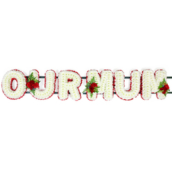 The image captures a classic funeral flower tribute spelling "OUR MUM" in large, bold capital letters, set against a bright, uncluttered white background that gives the flowers centre stage. Each letter is meticulously shaped using masses of tiny white chrysanthemum florets, arranged so tightly that the underlying frame disappears beneath a thick, soft-looking layer of petals. This expanse of white brings to mind purity, calm, and the gentle stillness of a chapel in Stanmore before a service begins. Around the edge of every letter, a precise red border has been created with small, velvety blooms, likely red spray carnations. Their deep crimson hue draws a clean outline around the letters, ensuring the message remains clear when viewed from across a church aisle or at the front of a crematorium chapel. Three clusters of red roses, framed by lush green foliage and delicate ferns, weave a more personal tone through the piece. One cluster rests in the gap between the "O" and "U", a second sits between the "U" and the first "M", and the third accents the end of the final "M". These roses bring richness and a gentle fragrance, symbolising deep gratitude and enduring love for a mother whose presence shaped everyday life around Stanmore's quiet streets and parks. Slight hints of a dark green supporting rail are visible behind the blooms, indicating the sturdy structure that connects the letters and makes them easy to display on stands, hearses, or gravesides. The overall mood is tender and respectful, a floral tribute that speaks softly but clearly of love, loss, and treasured memories.