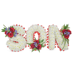 Arranged with considered care and local sensibility, this three-dimensional floral tribute spells out SON in bold, softened letters formed from tightly clustered white spray chrysanthemums, their tiny petals creating a pillowy, serene texture against a pure white backdrop. The sculpted letters are neatly outlined in a vivid red satin trim, pleated into a scalloped edge that both accentuates the typography and provides a formal, respectful frame. At three measured points-top-left of the S, bottom-centre of the O, and top-right of the N-are rich accent groupings: deep red roses with velvety petals serve as the emotional centre, interspersed with tall, narrow blue-purple spikes such as Liatris that introduce vertical rhythm and a cool counterpoint, while lush dark-green foliage and delicate fern fronds trail and soften the hard edges. The overall effect is somber yet elegant, the red and white palette speaking of purity, love and remembrance. In soft daylight the chrysanthemums read almost luminescent, while the roses give depth and a warm scent that comforts. As Stanmore neighbours often request for funerals near the Jubilee line station or at services around Canons Park, this style of personalised lettering is a traditional, deeply meaningful choice. Flowers Stanmore can replicate this arrangement for local funerals or memorials across Stanmore and neighbouring Harrow, delivering with sensitivity and the careful workmanship expected at a family farewell.