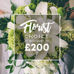 From Flowers Stanmore, a radiant white and lime green bouquet stands out with poised simplicity. Dominant white lilies rise at the center, their petals opening with a soft, ethereal glow, while lime green blooms-reminiscent of Green Trick dianthus or viburnum-like textures-give a bright contemporary lift. Surrounding whites, such as ranunculus or spray roses, add volume and gentle texture, and rich dark green leaves weave through the stems to create depth and a lush, garden-like feel. Held by a person, with a hint of light attire in the background, the arrangement suggests a Stanmore wedding, anniversary, or a thoughtful gift to mark a milestone in Harrow's leafy streets. A clean white square frame sits at the heart of the image, bearing Florist Choice in a delicate script at the top, BOUQUET in bold uppercase beneath, and a prominent price at the bottom that signals premium quality. This classic yet fresh design embodies the craft of Flowers Stanmore and is ideal for same-day delivery across Stanmore, Canons Park, and Edgware Road, bringing brightness to celebrations and everyday moments alike.