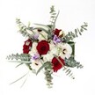 With every glance, this Stanmore bouquet evokes a sense of warmth, optimism, and thoughtfully curated beauty. Lush, velvet-red roses form the passionate core of the design, their depth reflecting romantic occasions and joyful toasts among friends on Stanmore's welcoming avenues. Bright white gerberas and their bold brown centers circle around, radiating positivity and confidence-a perfect echo of gatherings in Stanmore Place or the gentle light of a winter sun. Soft, fluffy white spray chrysanthemums add a luminous halo, their delicacy enhancing the sense of comfort and ease that pervades the arrangement. Subtle lavender lisianthus, lightly integrated, soothe the eye and lift the composition with their cool pastel touch, akin to the peaceful corners of Canons Park. Generous arcs of silvery eucalyptus spread gracefully outward, infusing the bouquet with modern freshness and an invigorating hint of cool fragrance. Fine green foliage threads discreetly through, suggesting an underlying backbone of natural structure. Illuminated in clear, balanced light, every bloom and detail comes alive-a testament to the care and instinctive artistry of Stanmore's local florists. This bouquet is a celebration of contrasts and harmony, perfect for a milestone birthday, an elegant dinner table, or an affectionate surprise for someone cherished in the community.