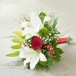 Resting atop a subtle, pale grey and beige textured backdrop, this lush hand-tied bouquet embodies the classic romance and understated sophistication cherished in Stanmore. The focal point is a striking blend of pure white lilies-some open, exposing their elegant gold-centred petals, others elongated and poised to bloom-alongside a rich, deep red rose at the very centre, its velvety spirals unfurling in dramatic fashion. Throughout the arrangement, mossy-green trick dianthus and fine button chrysanthemums add plush, contemporary texture, echoing the unique beauty found in Stanmore's landscaped parks. Scattered sprigs of airy white Gypsophila lend a feeling of lightness, balancing the larger forms of the lilies and rose, while clusters of glossy red hypericum berries inject lively colour and joyful vibrancy. The bouquet is thoughtfully surrounded by broad emerald leaves and feathery greenery, enhancing its full, organic silhouette. All stems are securely wrapped in a bold red satin ribbon, a finishing touch that unifies the composition and hints at the celebratory moments this bouquet might grace. Ideal for weddings, anniversaries, or cherished gifts within Stanmore and nearby areas, this arrangement from Flowers Stanmore eloquently expresses love, joy, and lasting promises-crafted by hands well-versed in the floral elegance of HA7.