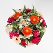 This jubilant bouquet is a feast for the senses, conjured up by the talented hands of Stanmore's local florists to mark life's happiest moments. In the center, orange gerberas burst with radiant energy, their petals bright and playful against the softer pink tones of blush roses and deep, plush magenta carnations. Scattered among them, stems of snowy white alstroemeria and tiny daisies shimmer, as if dew-kissed on a cool morning stroll through Stanmore Country Park. The arrangement is framed by abundant, glossy green leaves, providing a lush but balanced setting that underscores each flower's unique charm. The colour scheme-rich but harmonious-melds vivid orange and magenta with gentle whites and pinks, exuding warmth and inviting optimism. With its gentle, sweet fragrance and tactile richness, this bouquet belongs at the heart of any celebration, whether a birthday, reunion, or a spontaneous gesture of affection. Every bloom feels chosen to reflect the vibrancy and community spirit of Stanmore, promising a visual and sensory treat for anyone lucky enough to receive it.