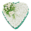 The photograph captures a peaceful heart-shaped floral tribute, meticulously arranged to express love and remembrance with quiet grace. At the centre of the design is a dense mass of small white chrysanthemums, each bloom nestled closely into the next to form a uniform, softly textured surface. The effect is that of a plush white cushion or blanket of petals, evoking comfort, purity, and a gentle farewell. Framing this floral heart is a rich emerald green satin ribbon, precisely pleated to create a scalloped border that runs around the entire perimeter. The ribbon's silky sheen stands out against the matte softness of the flowers, giving the tribute a polished, respectful finish ideal for funeral services and memorials in the Stanmore area. In the upper left curve, an elegant accent spray provides a focal point. Two fully opened white roses sit at the centre of this cluster, their velvety petals spiralling outward in generous layers. Around them, smaller white flowers-similar to freesias or other delicate blooms-add subtle detail and a sense of lightness. A mix of lush green foliage, from broad, glossy leaves to slender, feathery stems, surrounds and supports the flowers, some of it trailing gently over the chrysanthemum base. The tribute is photographed against a bright white background, free from distractions, so that the crisp whites and deep greens appear vivid and clear. The overall impression is one of calm, reverent beauty, the kind of heart-shaped arrangement chosen to honour a loved one's life at a local chapel, crematorium, or graveside service in Stanmore, offering a tender, visual expression of sympathy and enduring affection.