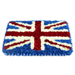 A finely detailed Union Jack floral tribute is shown, rectangular and gently domed, crafted entirely from small, tightly packed flowers that recreate the British flag with precision and care. The composition sits against a plain white background, drawing all attention to the interplay of red, white, and blue. A deep, velvety layer of blue chrysanthemums provides the foundation, each bloom nestled closely together so that the surface looks soft and seamless, like a plush cushion. Over this base, the St George's Cross is shaped from bright white chrysanthemums, forming strong vertical and horizontal bands that meet cleanly in the centre. Cutting across these, bold red stripes of carnations mark St Patrick's Cross, the richly coloured petals adding warmth and depth, carefully edged with fine white lines to keep the classic Union Jack design crisp and accurate. The gentle curvature of the arrangement creates soft shadows and highlights, giving the impression that the floral flag is gently rising from the surface, ready to rest atop a coffin or be placed with reverence at the front of a service space. Along the bottom border, a pleated royal blue ribbon finishes the piece, its subtle satin sheen matching the depth of the blue flowers and adding a refined, formal touch. The tribute feels ideal for a military funeral, a veteran's memorial, or a farewell for someone who held their British identity close, especially within the close-knit community of Stanmore. Imagining it delivered to a service near Stanmore station, Canons Park, or along the leafy streets around Stanmore Hill, the overall impression is one of solemn pride, deep gratitude, and heartfelt remembrance crafted by a skilled local florist.