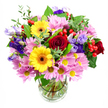 This image shows a lush, mixed-colour bouquet displayed in a clear glass vase, set against a plain white background that allows the flowers to be the sole focus. At the heart of the arrangement, deep red roses open in soft, velvety curves, bringing a sense of romance and richness. Just beside them, two bright yellow gerbera daisies with dark brown-orange centres stand confidently, their sunny faces adding a burst of happiness that feels right at home in a welcoming Stanmore living room. Encircling these main blooms, clusters of pink daisies or chrysanthemums create a billowing layer of colour, each flower made up of many thin petals around a small yellow centre, giving the design fullness and a gentle, friendly charm. Threaded throughout are elegant lisianthus blossoms in purple and lavender shades, their bell-like shapes and slightly ruffled edges adding cool sophistication and depth. Here and there, rounded red hypericum berries peek out from between the petals, their glossy surfaces catching the light and offering a modern, textural contrast. A selection of greenery in multiple tones of green-broad, shiny leaves and finer, lighter stems-frames the entire bouquet, making it look freshly gathered from a well-tended garden off Stanmore Hill. Through the clear glass vase, neatly trimmed stems can be seen fanning out in clean water, reflecting the careful work of the florist and the bouquet's freshness, ideal for local delivery. The overall impression is one of warmth and celebration, suitable for birthdays, congratulations, or simply brightening a home in Stanmore with colour, fragrance, and a sense of thoughtful care.