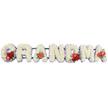In this touching funeral arrangement, the word GRANDMA is spelled out in substantial, upright letters, placed side by side in a neat horizontal row so that the message reads clearly from a distance, whether displayed in a Stanmore chapel or beside a graveside. Every letter is fully covered with white cushion chrysanthemums, their compact, button-like blooms pressed close together to create a thick, luxurious layer of petals that appears soft and velvety. A gentle trim of pale lilac or light purple ribbon runs just beneath the flower heads, framing each letter with a delicate halo of colour that introduces quiet depth and a tranquil, almost spiritual mood. Rich red accent flowers are positioned with care to symbolise love and remembrance. On the opening G, a small cluster of velvety red roses is tucked into the curve, accompanied by a distinctive red-and-white variegated calla lily whose smooth, tapering petals curl into an elegant funnel. The first A is marked at its base by a single heart-shaped red anthurium lily, its highly polished surface reflecting the light like lacquer, standing in bold contrast to the soft chrysanthemums. In the centre of the tribute, the M features a further grouping of deep red roses and another red anthurium, drawing the eye naturally towards the heart of the word. The final A is adorned with one more red anthurium bloom, visually linking the closing letter with those earlier highlights. All of the letters are supported by a discreet dark green frame beneath, which provides stability while adding the slightest hint of foliage tone. The arrangement as a whole radiates respect, tenderness, and quiet strength, making it a meaningful floral farewell for a much-loved grandmother from her family in Stanmore and the surrounding neighbourhoods.