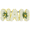 A carefully modelled, three-dimensional sympathy tribute spells the name NAN in bold capital letters, each letter built from a dense carpet of small, pristine white chrysanthemum spray blooms that give the surface a cloud-soft, tactile quality. A cheerful, precise border of petite, sunny yellow button chrysanthemums or miniature carnations traces the outer edges of every letter, lending a bright halo that crisply defines the shapes against the white backdrop. The two outer 'N' letters carry elegant focal clusters of deep green glossy foliage - reminiscent of camellia or ruscus leaves - gathered around tighter yellow rosebuds and smaller yellow blooms, which add depth, warmth and a gentle lift of colour; the central 'A' is deliberately left unadorned so the pure white texture reads cleanly and calmly. Behind the upper sections a slim, unobtrusive dark-green or black horizontal support bar connects the letters and suggests a stable, freestanding display suitable for a funeral nave, chapel lectern or graveside. Soft studio lighting from above catches the satin sheen of the yellow blooms and brings out the subtle scent of fresh freesia and rose, while the ferns and glossy leaves provide a cool, verdant contrast to the warm yellow accents. Presented on a plain white background, the arrangement's classic palette of white, yellow and deep green reads as both respectful and hopeful - purity, memory and sunny remembrance held together with careful florist craftsmanship. This is the kind of personalised letter tribute a local florist might prepare for a service in Stanmore or at nearby Canons Park, conveying love, dignity and the gentle brightness of remembered days.