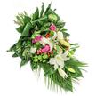 This delicate funeral spray, assembled by skilled Stanmore florists, resembles a heartfelt tapestry of garden and memory, designed for meaningful tribute. It cascades diagonally across a stark white field, echoing the quiet majesty of Stanmore's tree-lined streets. Wonderful white lilies take centre stage: some fully open and radiating purity, others still in promise within their buds. Nestled beside them are romantic pink roses and soft white spray carnations, their layered petals imparting depth and a sense of gentle comfort. Spherical green santini chrysanthemums punctuate the bouquet, their playful forms balancing the ruffled white blooms. Glossy, broad leaves-some folded artistically-form a rich, dark green backdrop, while lighter, airy greenery and palm fronds trail gracefully, suggesting the natural architecture of Canons Park. Vibrant red hypericum berries are thoughtfully placed, offering warmth and hopeful contrast. The whole arrangement is set aglow by soft, directional natural light, enhancing every detail from velvety textures to the varying greens. This spray is more than a collection of flowers: it's a soothing companion for times of remembrance in Stanmore, offering reflections of peace, love, and lasting respect in every carefully chosen stem.