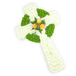 A carefully composed Celtic cross made entirely from fresh flowers, photographed on a bright white background and seen from a slightly elevated angle. The cross's structure is built from dense clusters of pristine white spray chrysanthemums whose small, ruffled petals create a soft, cushiony surface and a sense of quiet purity. Interwoven through the white are vivid apple-green button chrysanthemums that trace the circular ring where the cross's arms meet and appear in alternating panels along the horizontal arms, their compact, spherical shapes adding tactile contrast and a lively, contemporary rhythm to the design. At the very centre of the intersection, a tight cluster of three deep orange-gold roses provides a warm, luminous focal point; their layered petals glow against the cool whites and greens and are gently cradled by short sprigs of darker green foliage, suggesting fern or similar leaves that add depth and a natural frame. The lighting is soft and even, bringing out the velvety texture of the chrysanthemum heads and the subtle sheen on the rose petals while casting minimal shadow so the three-dimensional form reads clearly. The color palette - white, lime green, and golden orange - evokes an Irish sensibility without overwhelming the solemn mood, making the piece especially apt as a funeral tribute or memorial for someone with Celtic roots. A quiet scent of fresh chrysanthemums and a faint, honeyed rose perfume would be present in person; the workmanship shows considered floristry and a steady hand, the kind of detailed, respectful design local families in Stanmore might choose to honour a loved one.
