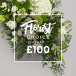 From Flowers Stanmore, a pristine Florist Choice Spray unfolds in white blooms and cool greens against a softly lit grey background, captured from an elevated angle that invites a quiet linger. The arrangement feels lush and full, with a gentle outward cascade that broadens toward the edges, letting textures of petals and foliage reveal themselves in patient detail. Dominant white hydrangeas cluster toward the top center, their cloudlike heads providing generous volume, while classic white roses punctuate the composition in a range of stages-from tightly furled buds to fully open, satin sheen blossoms. Delicate lisianthus rise and fold, their bell shapes touched with faint green, adding air and subtle movement. Interwoven there is an abundant spectrum of greens: feathery ferns curve gracefully along the bottom and right, soft grey-green eucalyptus softens the palette, and deeper, broader ruscus provides depth and contrast. Tiny clusters of pale green buds mark fresh points of light across the spray. Centered over the blossoms is a clean, thin white rectangular overlay bearing the product name and price. The word Florist appears in an elegant script, followed by CHOICE in crisp uppercase, then SPRAY beneath, and finally a price line rendered as £100. The overlay's gentle transparency lets the greenery show through, a visual nod to the craft beneath. This Florist Choice Spray exudes timeless elegance-an ideal sympathy tribute, refined gift, or sophisticated focal piece for a calm home. It's available for same-day delivery across Stanmore and surrounding NW London neighborhoods, a reassuring sign of local expertise, courtesy, and freshness from Flowers Stanmore.
