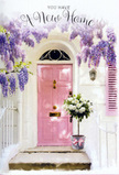 In this warmly composed Stanmore doorway, flowers and architecture come together to celebrate a fresh start. A blush-pink front door stands quietly confident at the centre, its colour soft yet inviting, framed by a whitewashed wall and a matching pastel shutter that catch the natural light in a flattering, diffused glow. The palette recalls the gentle tones of early evening walks around Stanmore Common or along the surrounding residential lanes. Above, luxuriant wisteria spills down in loose drapes of lavender and lilac blossoms, thick strands of flower clusters forming a natural arch that softens the straight lines of the building. Each bloom adds to the impression of a fragrant curtain, creating the sense that this is a cherished, lived-in home. Resting on the doorstep is a grey metal bucket, placed with the kind of care a florist shows when finishing a special delivery. From it rises a lush arrangement of white and cream roses, the blooms round and generous, petals overlapping in velvety whorls. Sprigs of fresh green foliage tuck in between the roses, their subtle textures and tones suggesting a freshly cut, garden-inspired composition. A satin pink ribbon is tied around the bucket, its hue echoing the door and pulling the pastel elements into a harmonious whole. Gentle light skims over stone, metal, and petal, casting relaxed shadows that give the scene depth and intimacy. The overall feeling is of a housewarming bouquet just delivered to a new Stanmore address, silently offering congratulations, comfort, and the heartfelt assurance that this doorway marks the beginning of many happy moments to come.