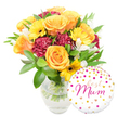 A joyful, carefully composed gift set photographed against a bright white backdrop: a clear glass vase cradles a generous bouquet of fresh, garden-style blooms, and a round white foil balloon leans gently at the lower right. Up close the arrangement reads as a warm, sunlit medley - large, peachy-orange roses with soft, spiralling petals form the visual heart, their satin surfaces catching a soft, morning light. Sprays of bright yellow gerbera daisies lift the mood like little suns, each with a distinct dark centre that adds a crisp contrast. Deep burgundy carnations, densely ruffled and velvety to the eye, tuck between the roses to give weight and a romantic depth. Slender white alstroemeria (Peruvian lilies) with pale speckling thread through the composition, their delicate shapes introducing air and refinement. A generous cloud of glossy green foliage - broad leaves and narrow sprigs - frames the stems, which are visible through the pristine water in the vase and speak to recent, careful conditioning. The balloon is white Mylar, decorated across its surface with scattered gold and hot-pink confetti dots and small heart motifs; in the centre, a flowing hot-pink script reads best Mum, the lettering both celebratory and intimate. The overall feeling is one of thoughtful celebration - a bouquet designed to make a mother smile, whether for Mother's Day, a birthday, or a simple thank-you. As a local florist composition, it evokes familiar comforts around Stanmore High Street and neighbourly deliveries to Canons Park and Stanmore Station, a present that looks as fresh in hand as it would on a mantel or kitchen table.